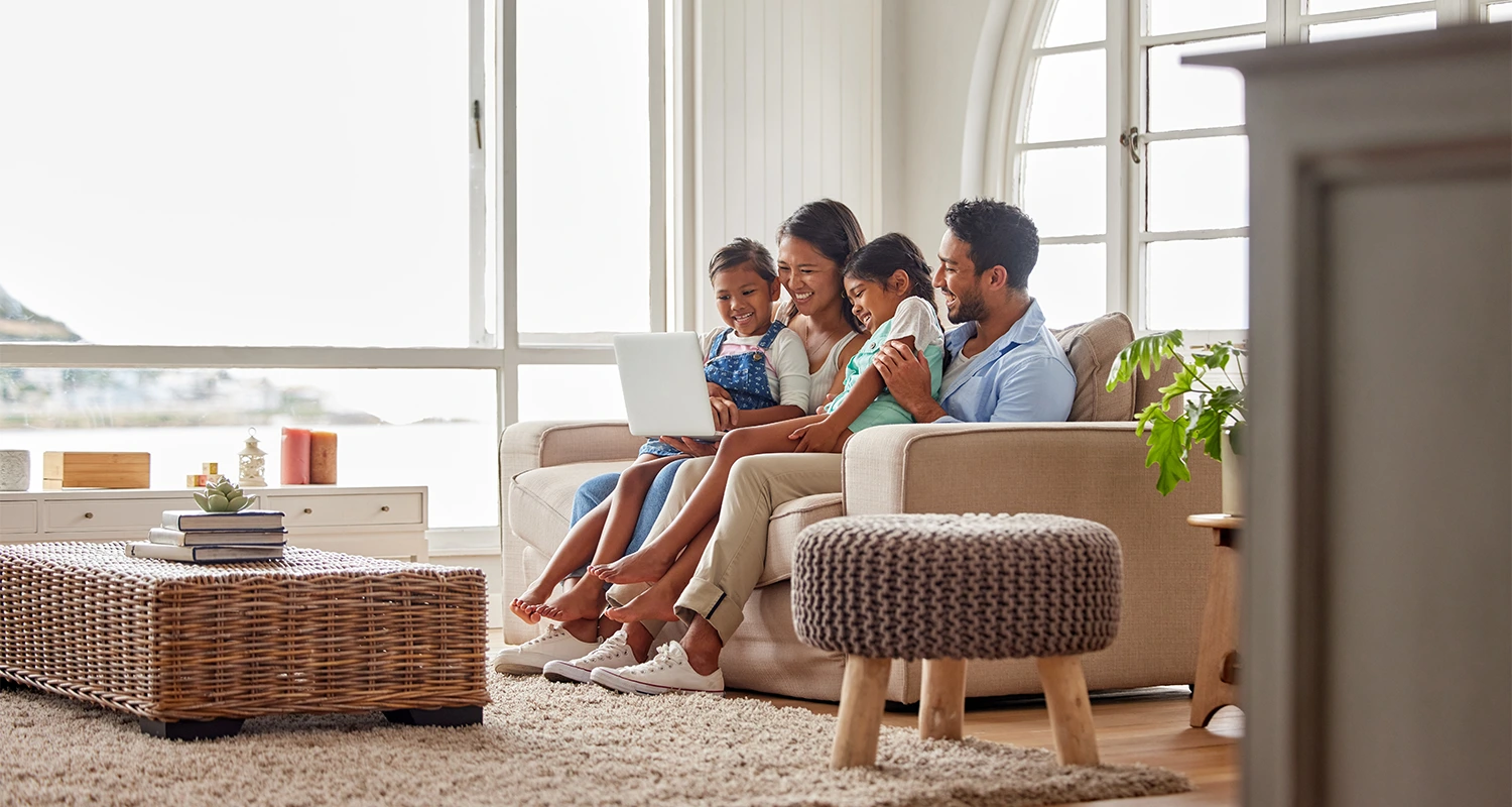 Family enjoying time together on a couch.