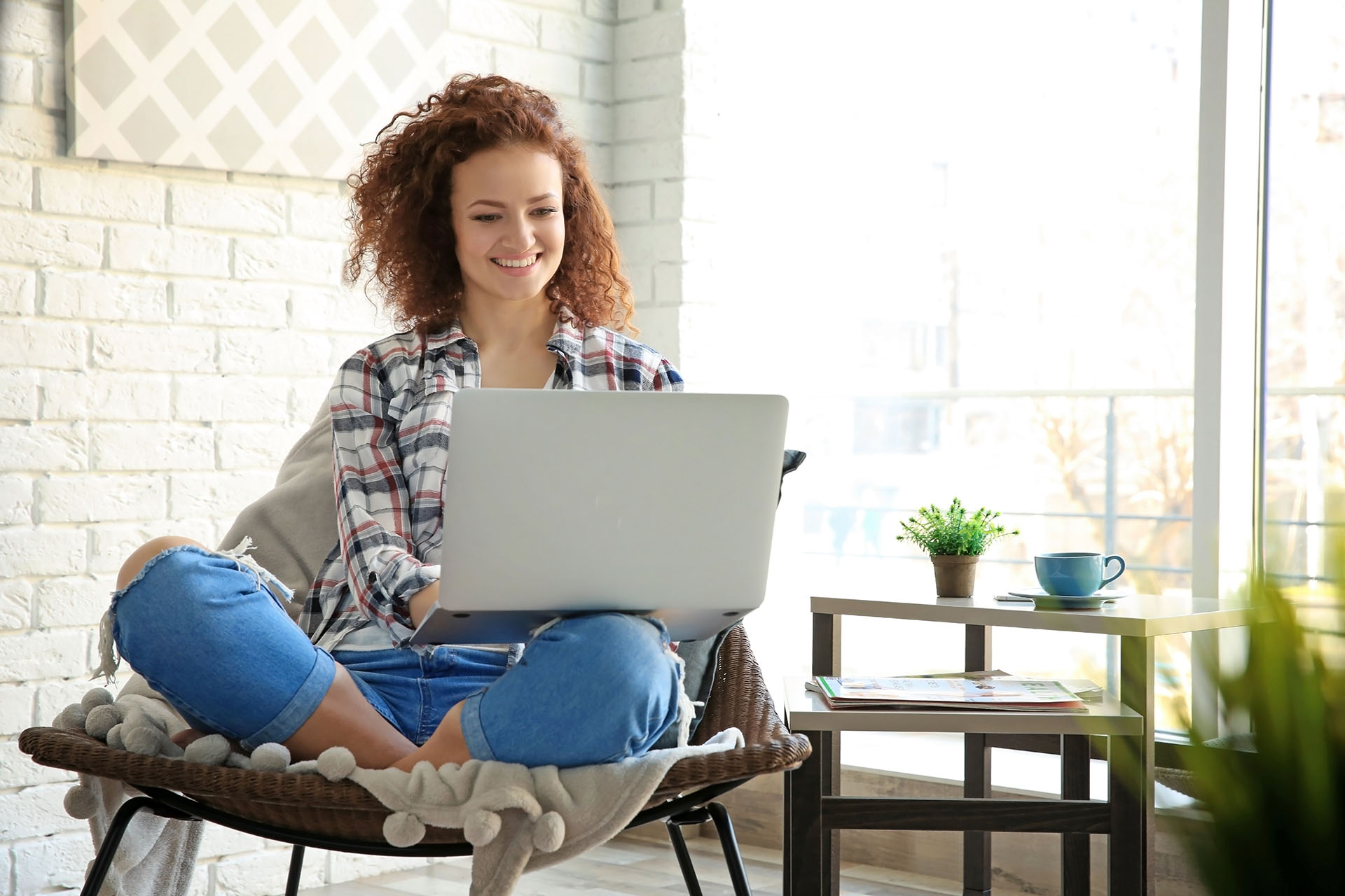 Woman using laptop at home.