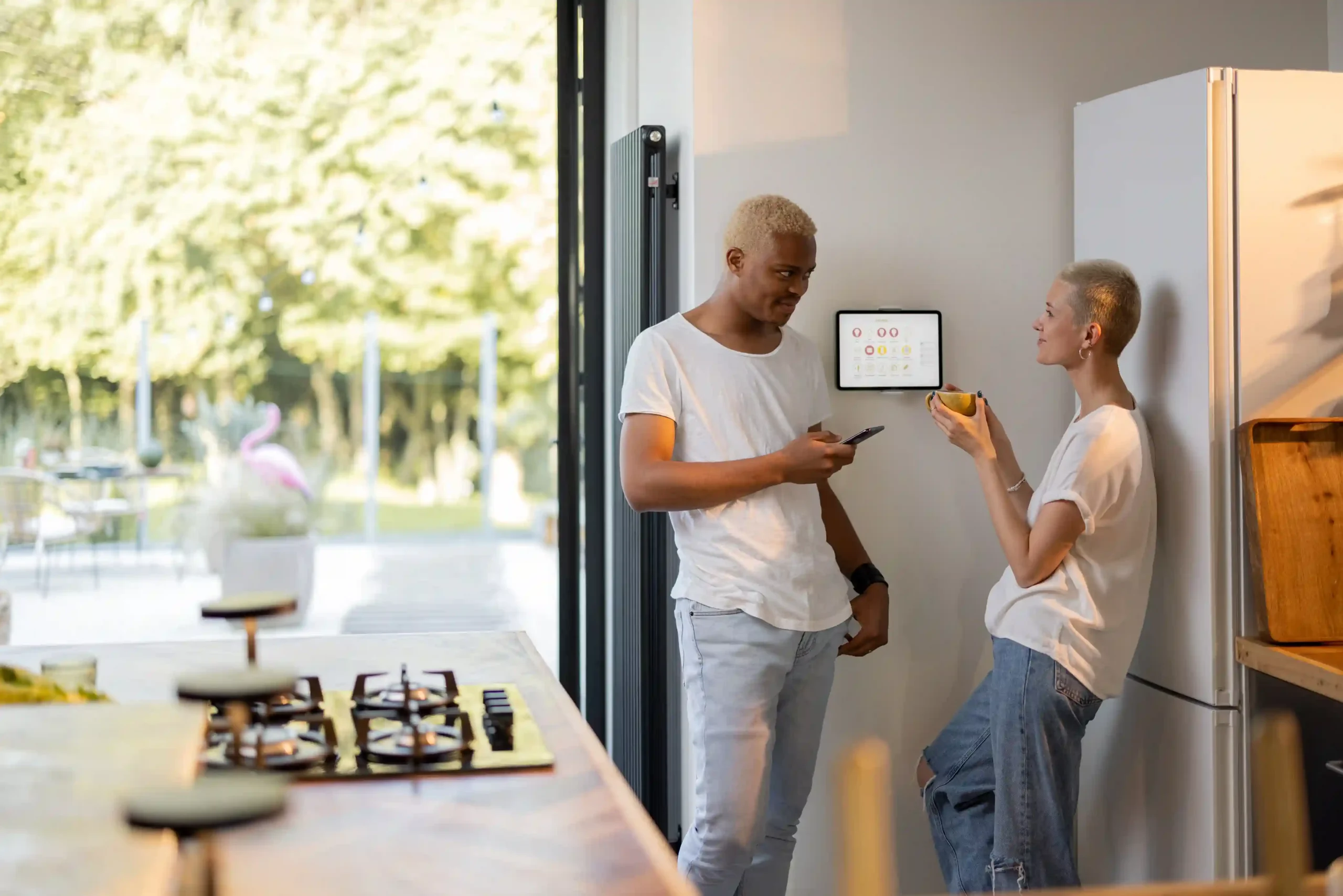 Two people interacting in a modern kitchen.