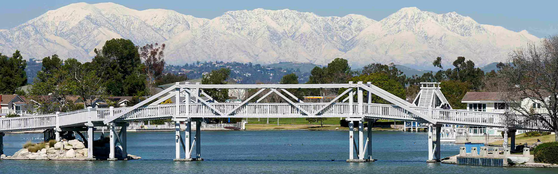 Scenic white bridge over a serene lake.