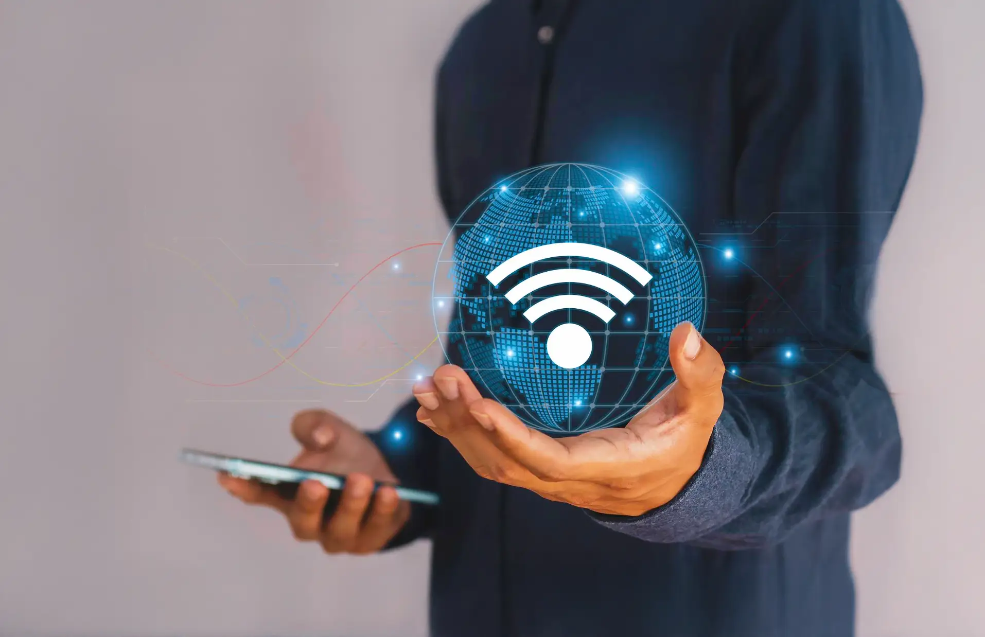 Person holding smartphone with wireless internet symbol.