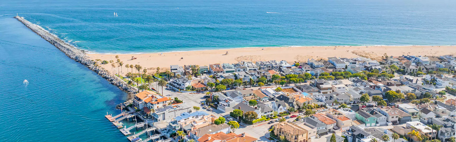 Aerial view of coastal homes and sandy beach.