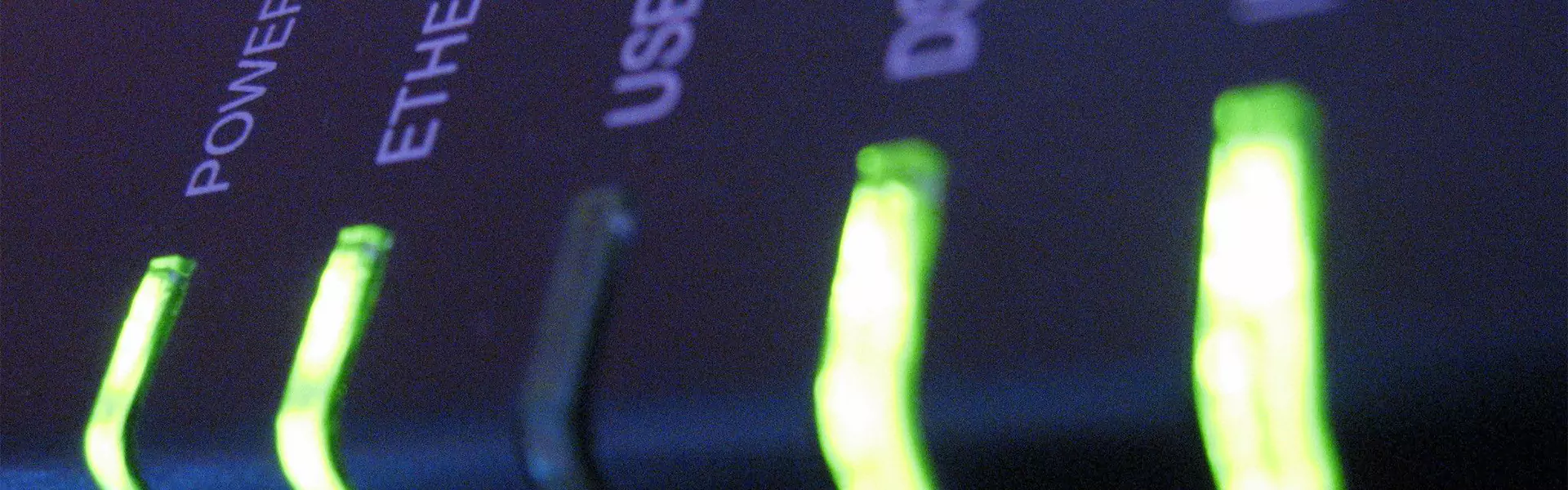 Close-up of illuminated network device indicators.
