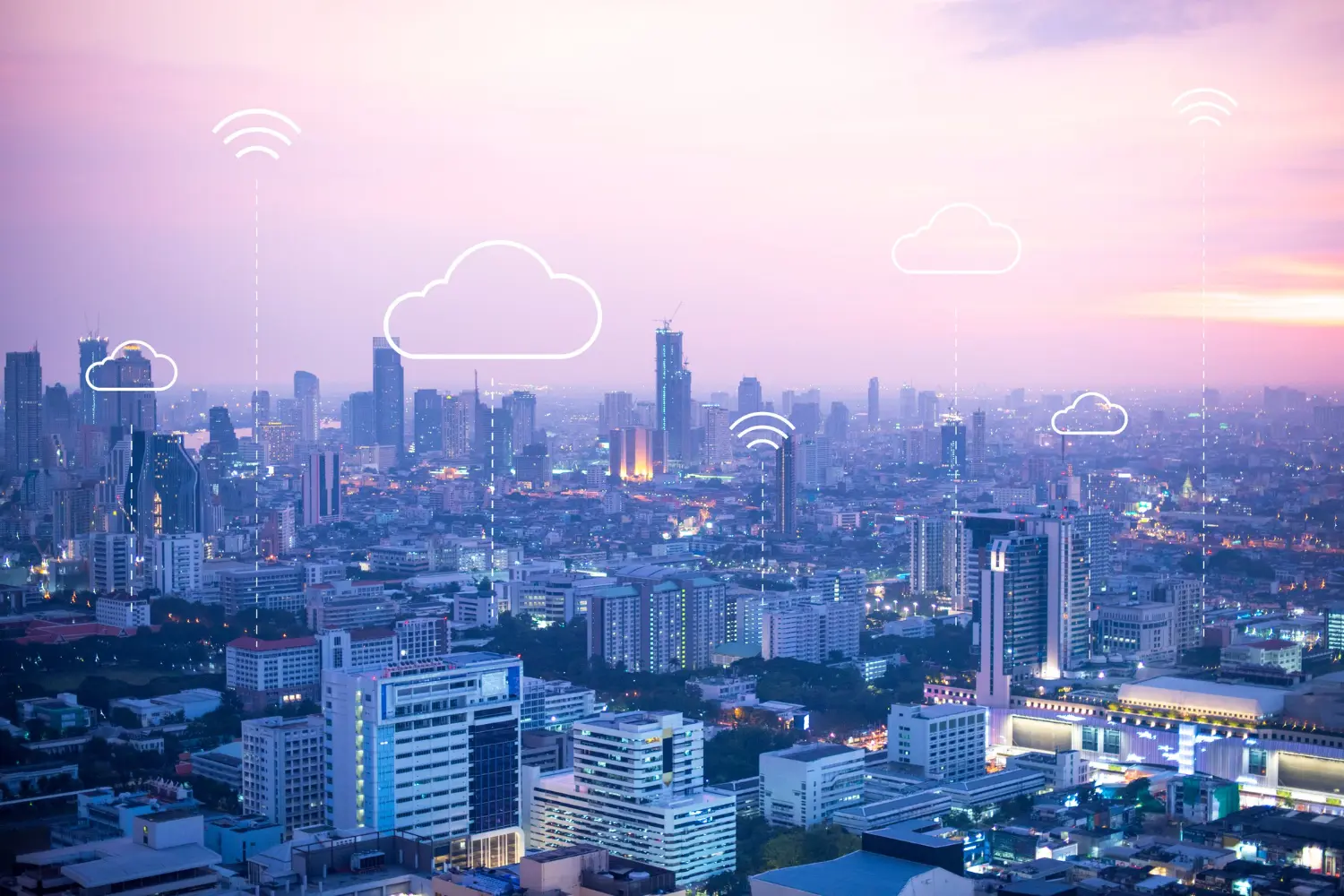 City skyline at dusk with cloud icons.