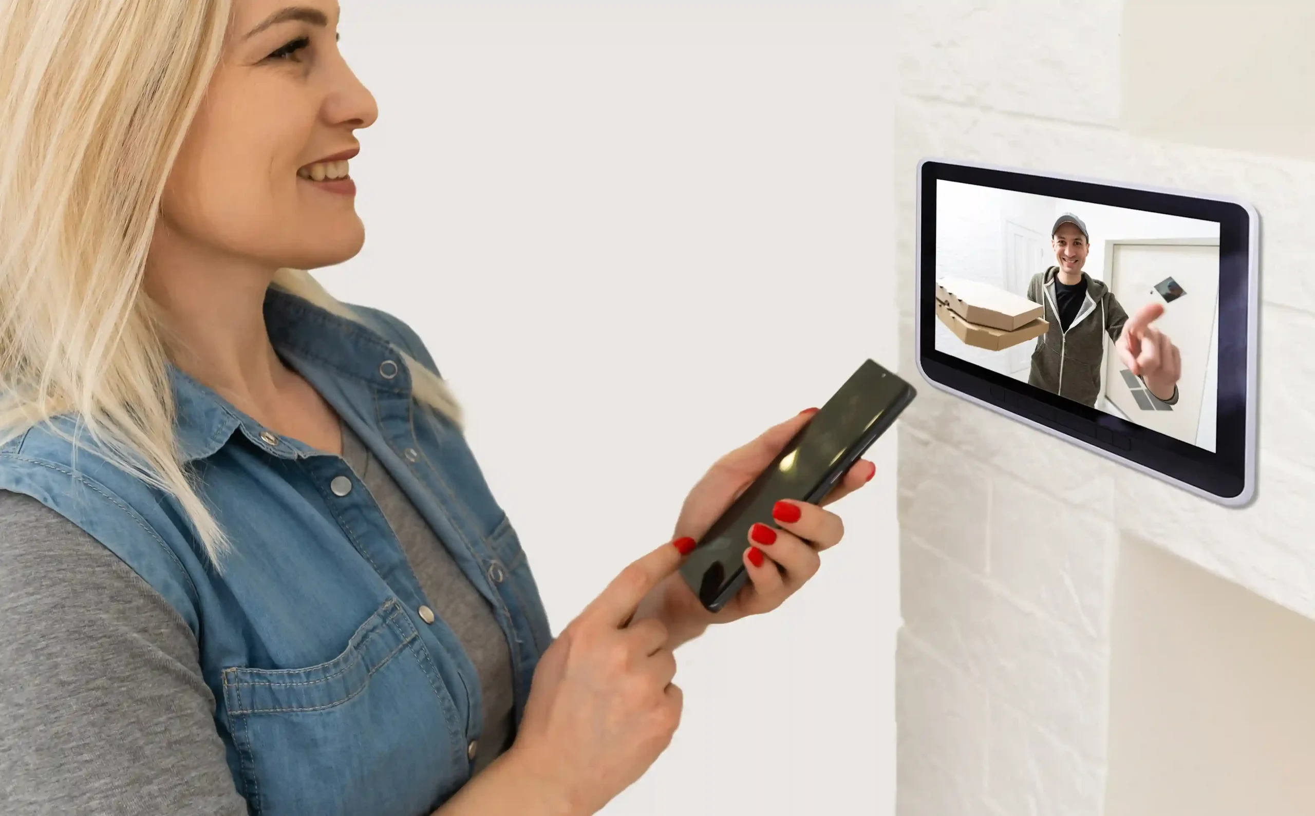 Woman interacting with video doorbell system.