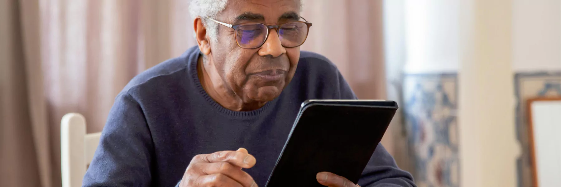 an elderly person using a tablet or their phone