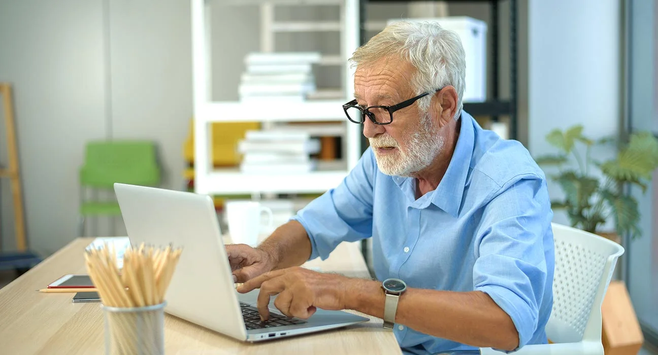 elderly person (or people) using a computer/laptop/phone