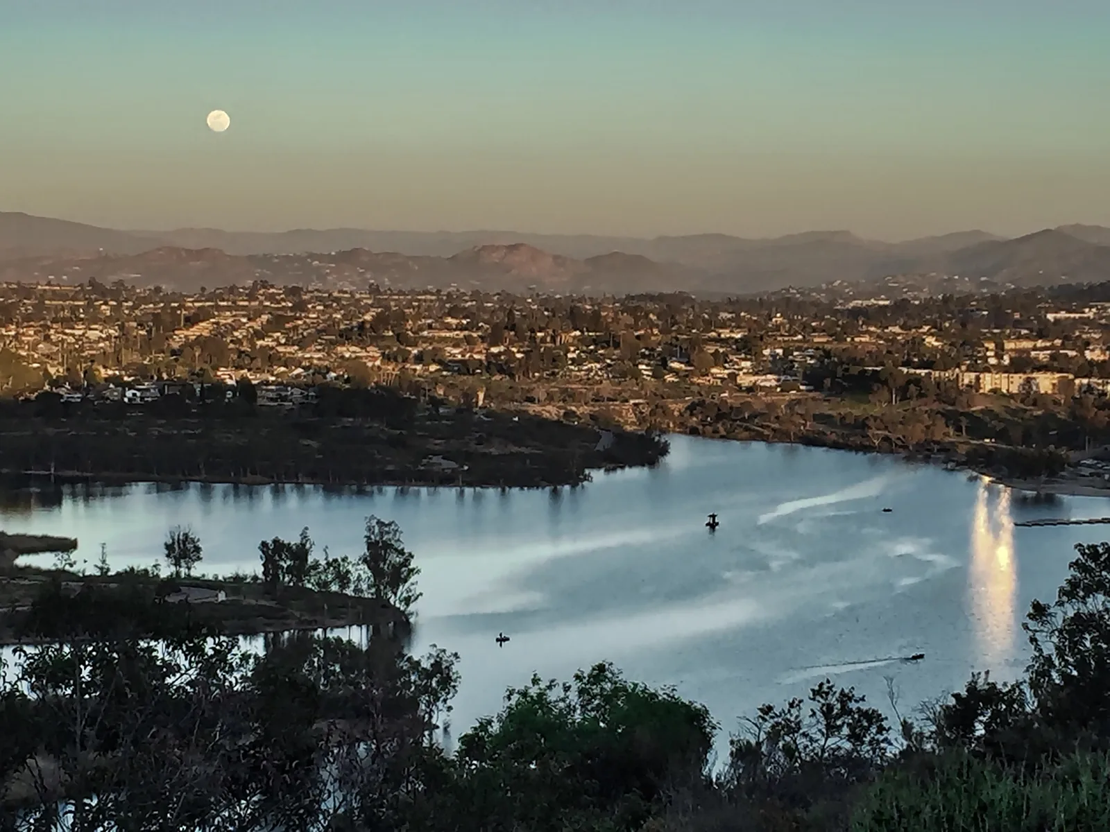 Moonlit lake view with mountains in the background