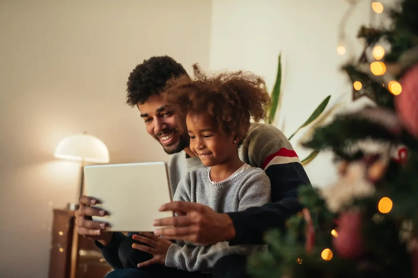 Father and daughter enjoying a tablet together.