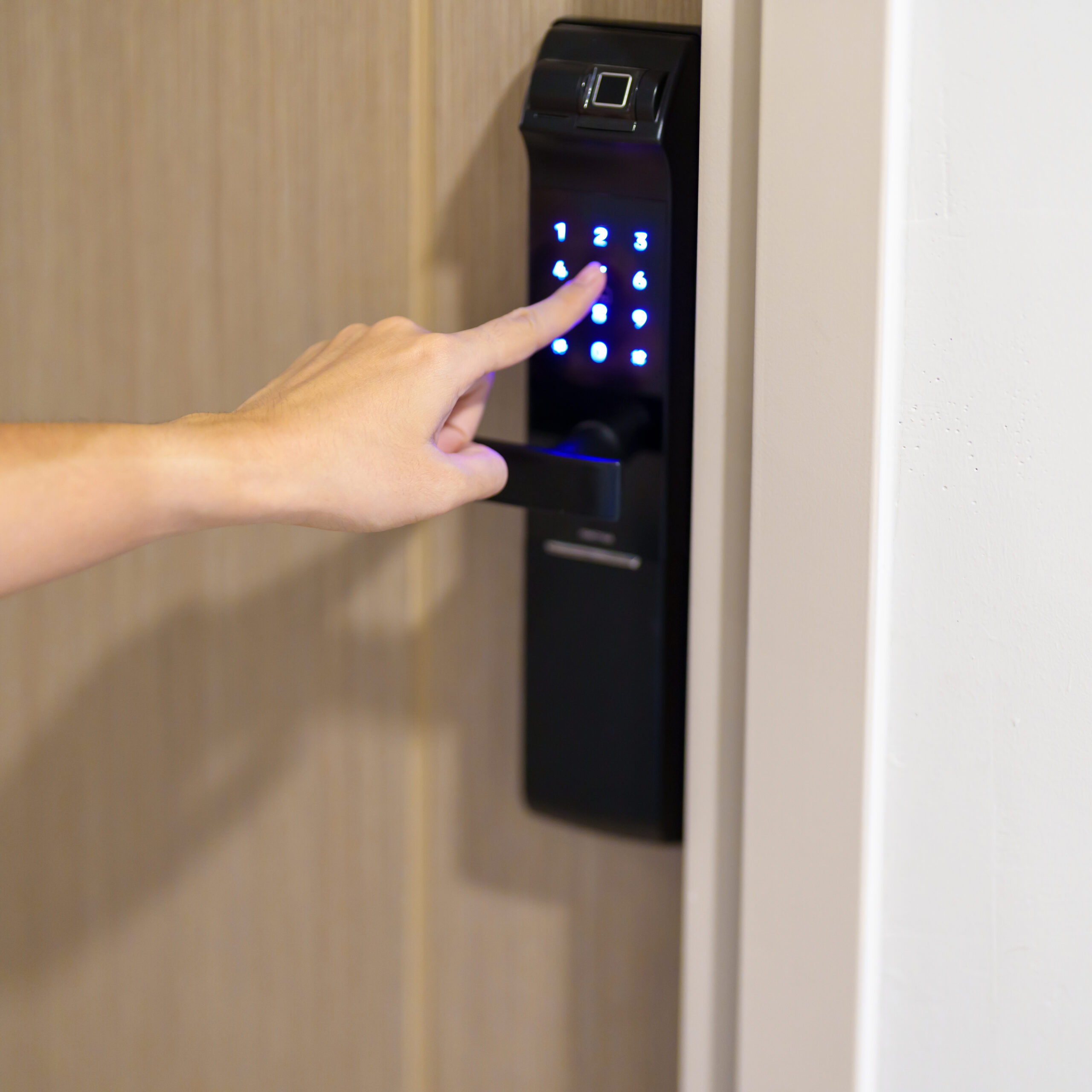 Person entering a code on a smart lock.
