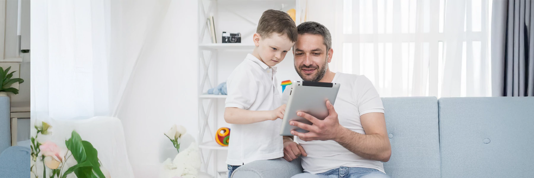 Father and son enjoying time together with tablet.