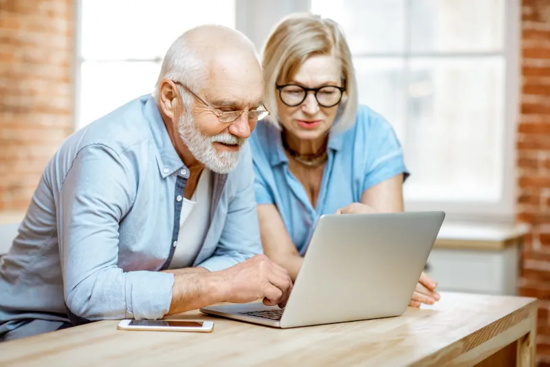 Older couple engaging with a laptop together