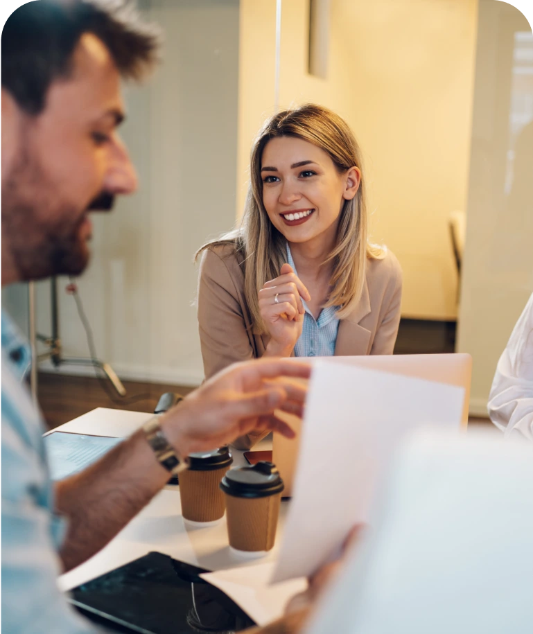Team collaborating during a meeting with coffee