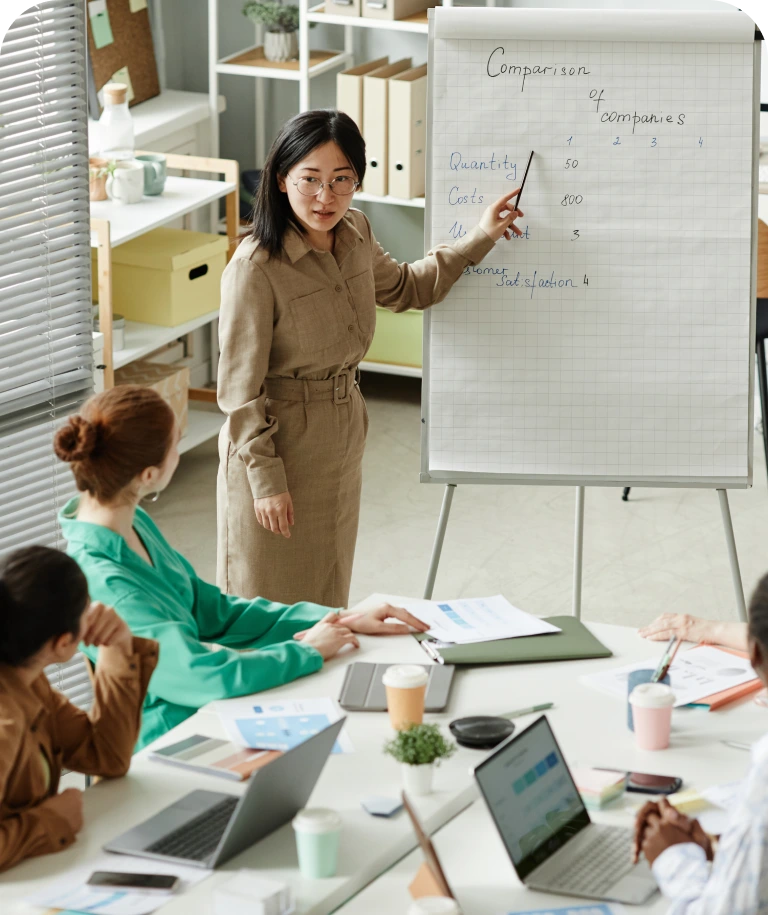 Business meeting discussing company comparison data