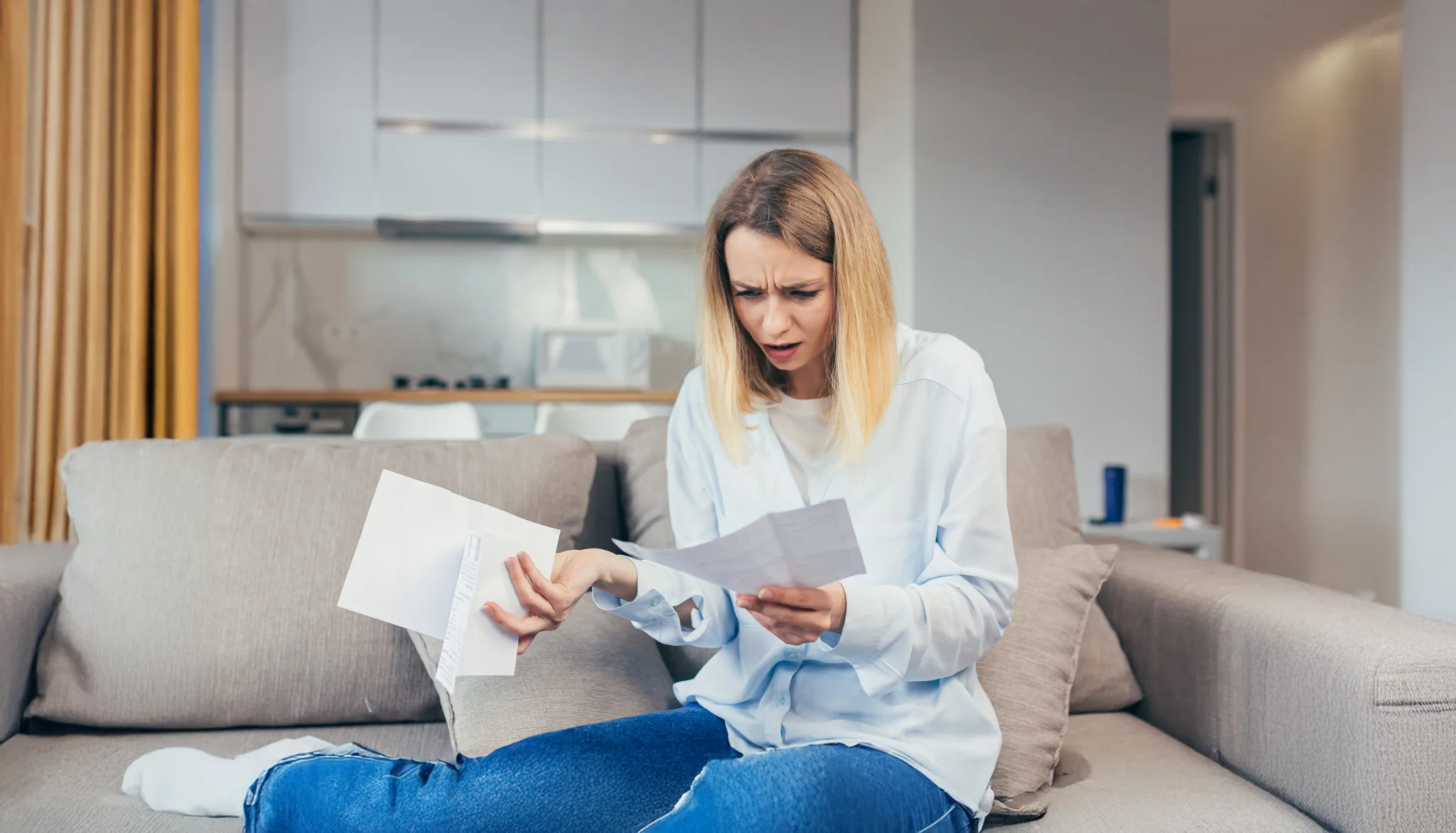 Person looking puzzled while reading important documents.