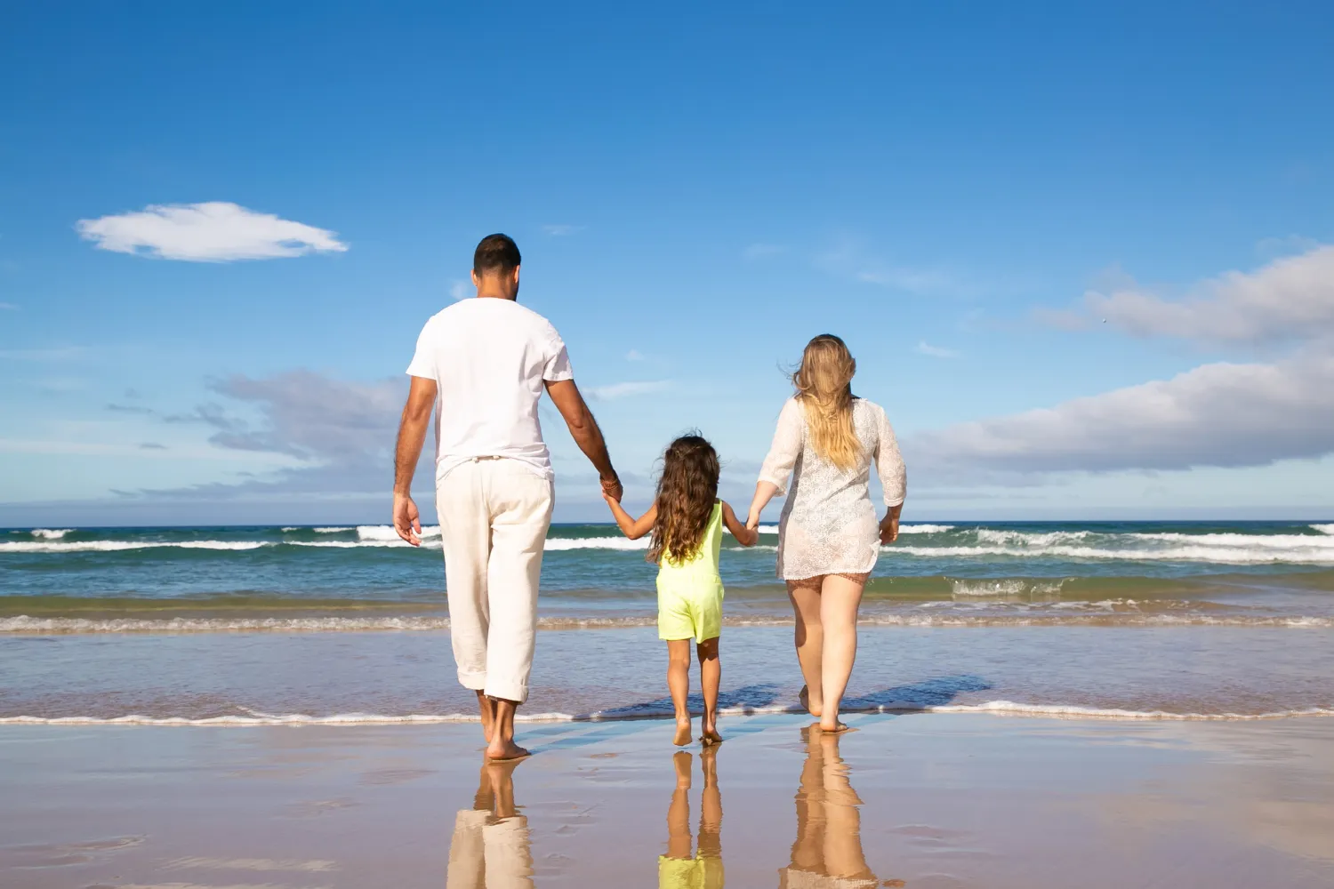 Family walking together along the beach.