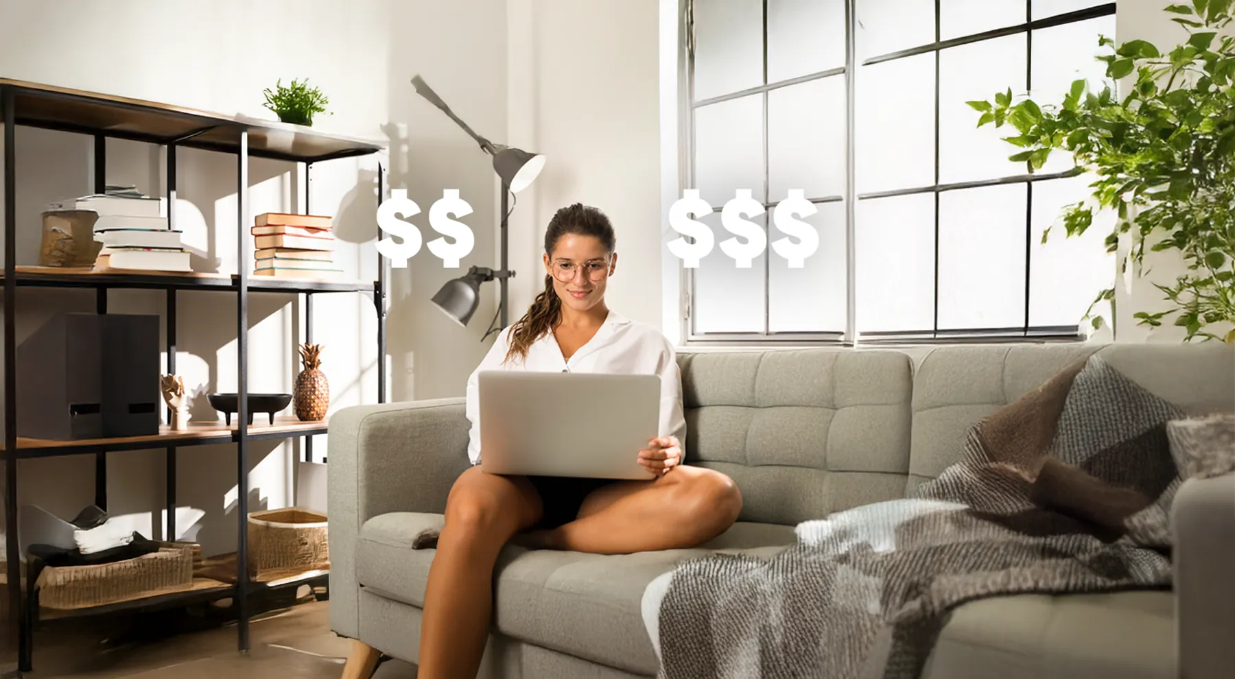 Person using laptop at home with money symbols.