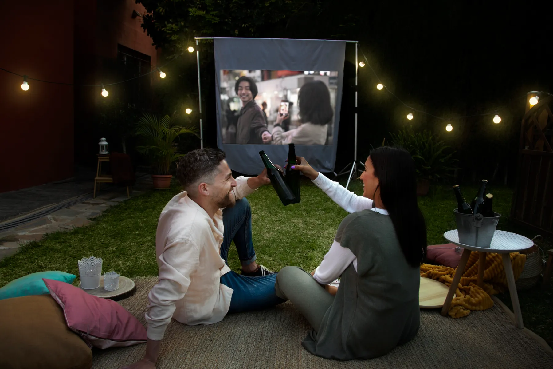 Couple enjoying a movie night outdoors.